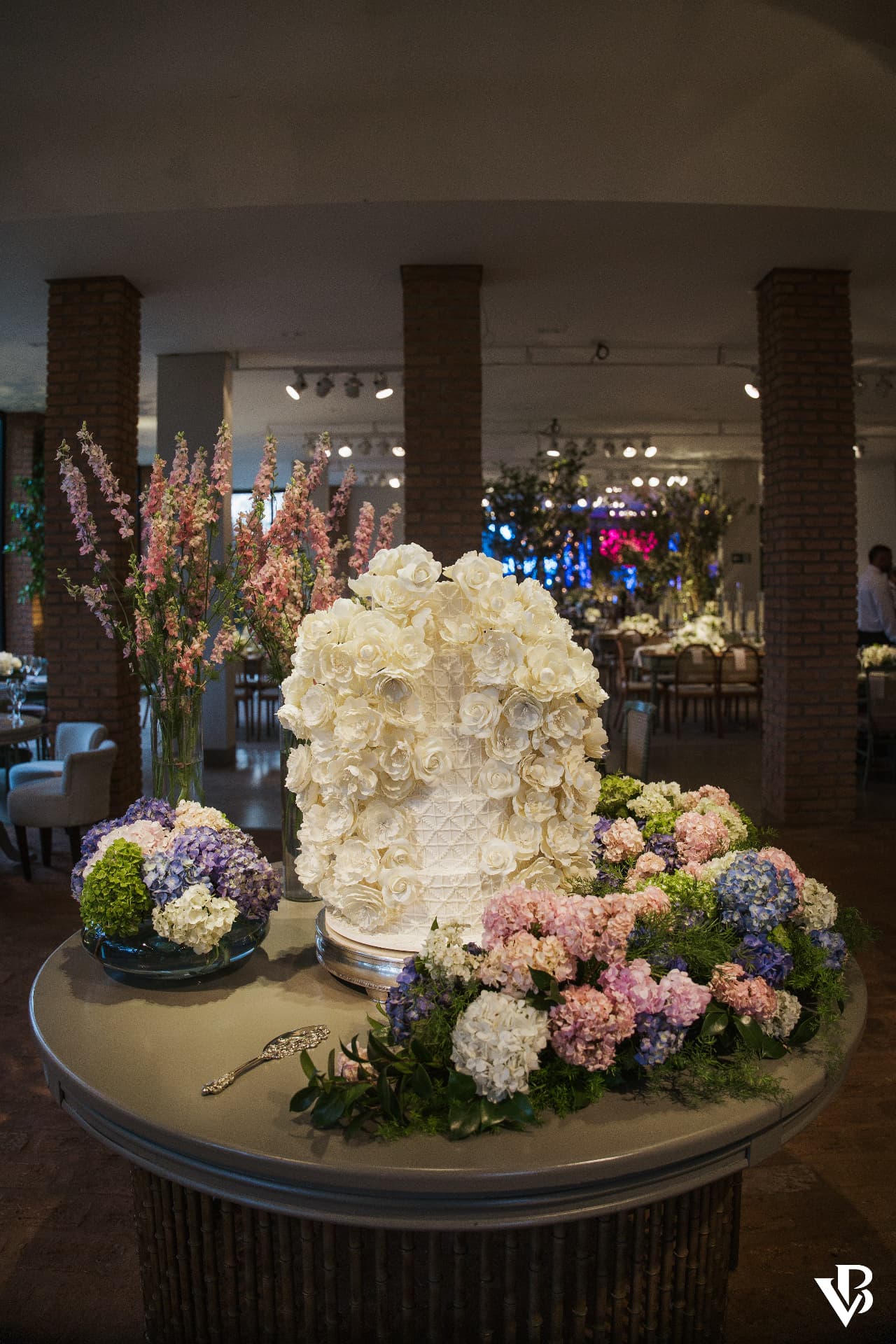 Lebbeke's cake and fine confections amidst floral arrangements at Ana and Arthur's wedding.