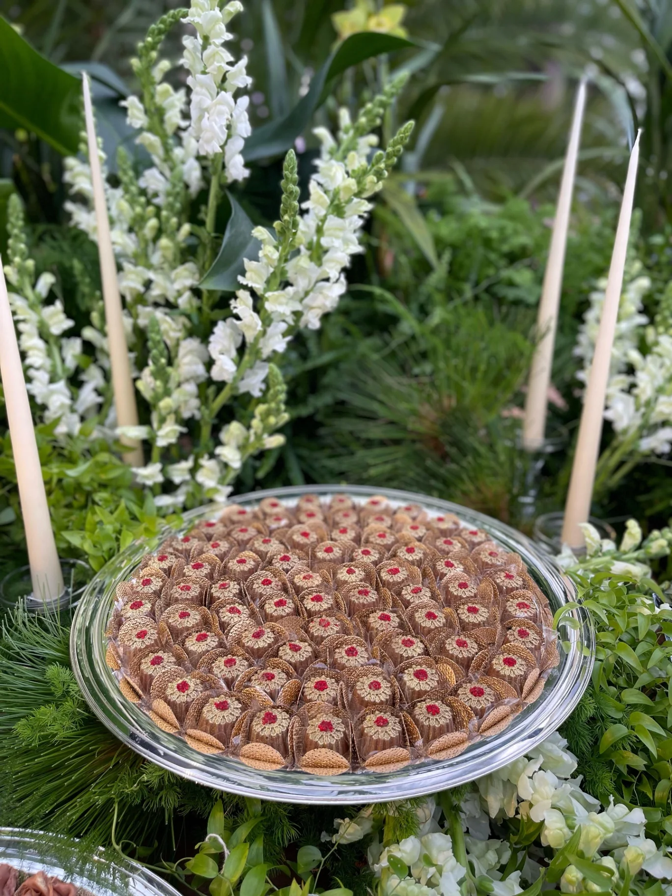 Pearlescent confections arranged amidst florals.