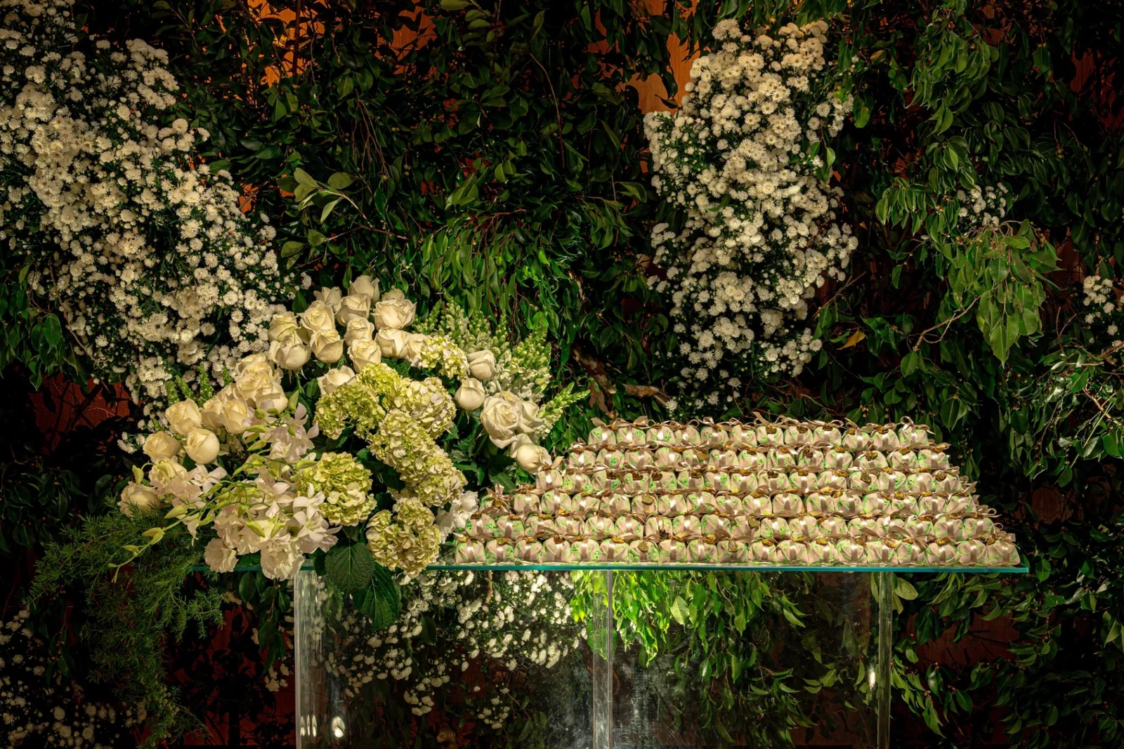 A signature dessert table featuring an array of flowers and bonbons.