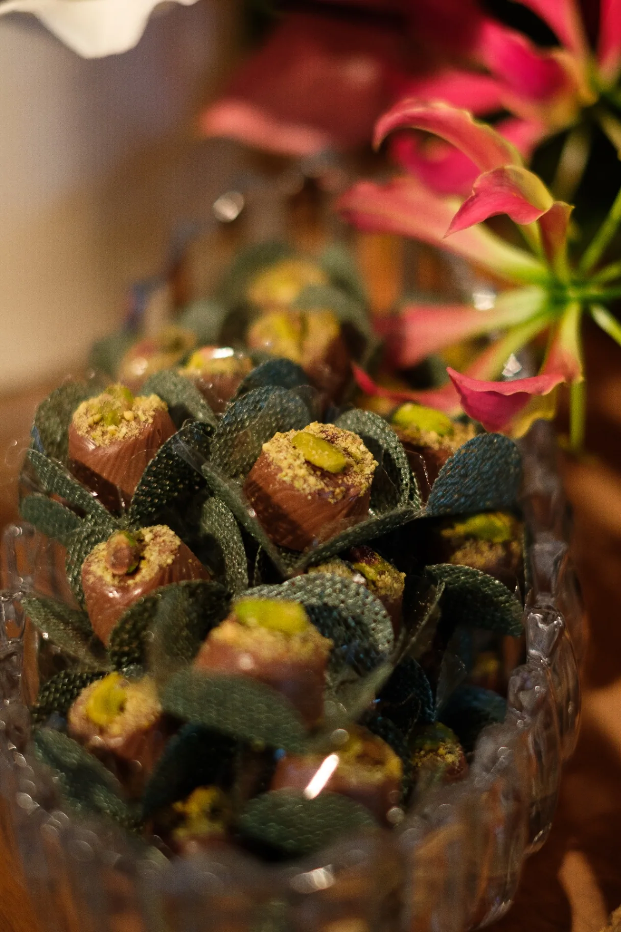 Pistachio bonbons decorated with sage leaves.