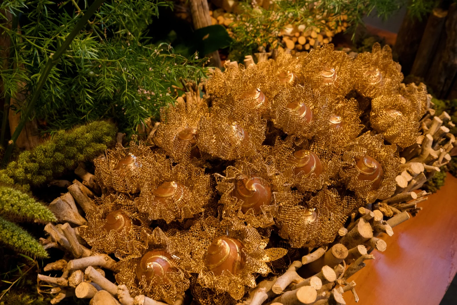 Fine sweets in gilded cups with foliage