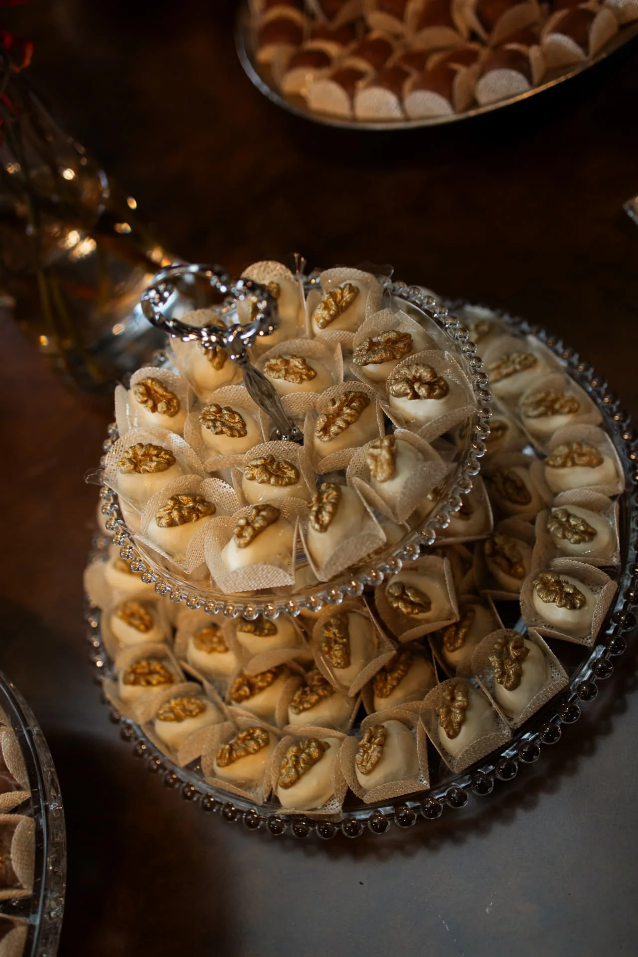 Lebbeke fine sweets with gilded walnuts on a crystal plate
