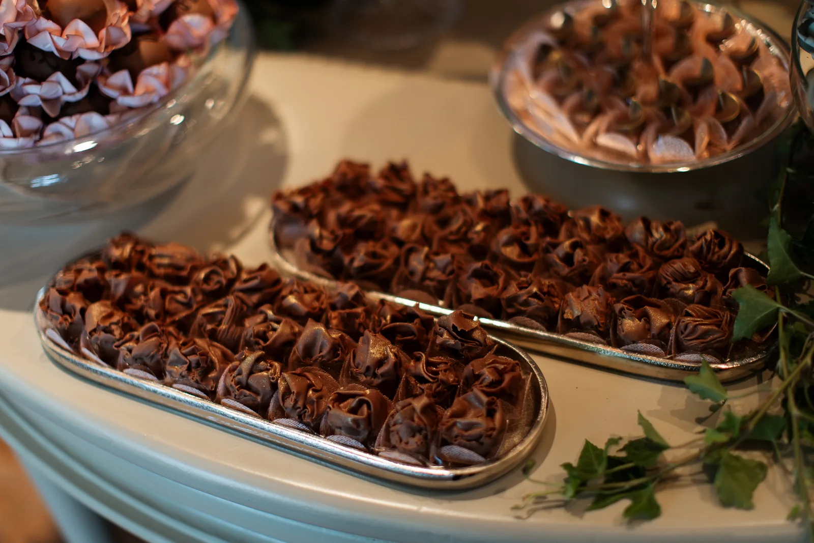 Trays of chocolate confections on a decorated table