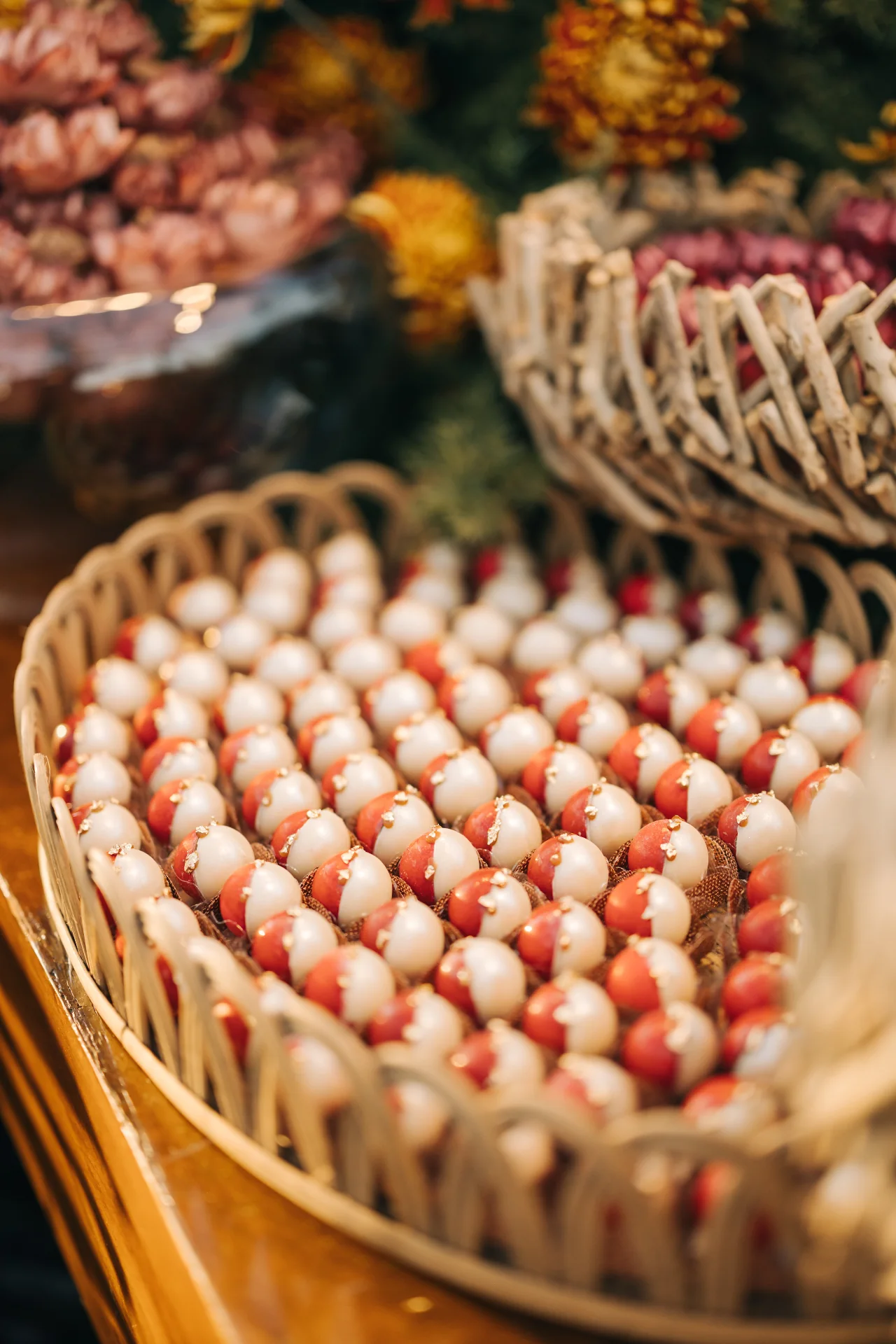 Pearly white and coral sweets on a rustic tray