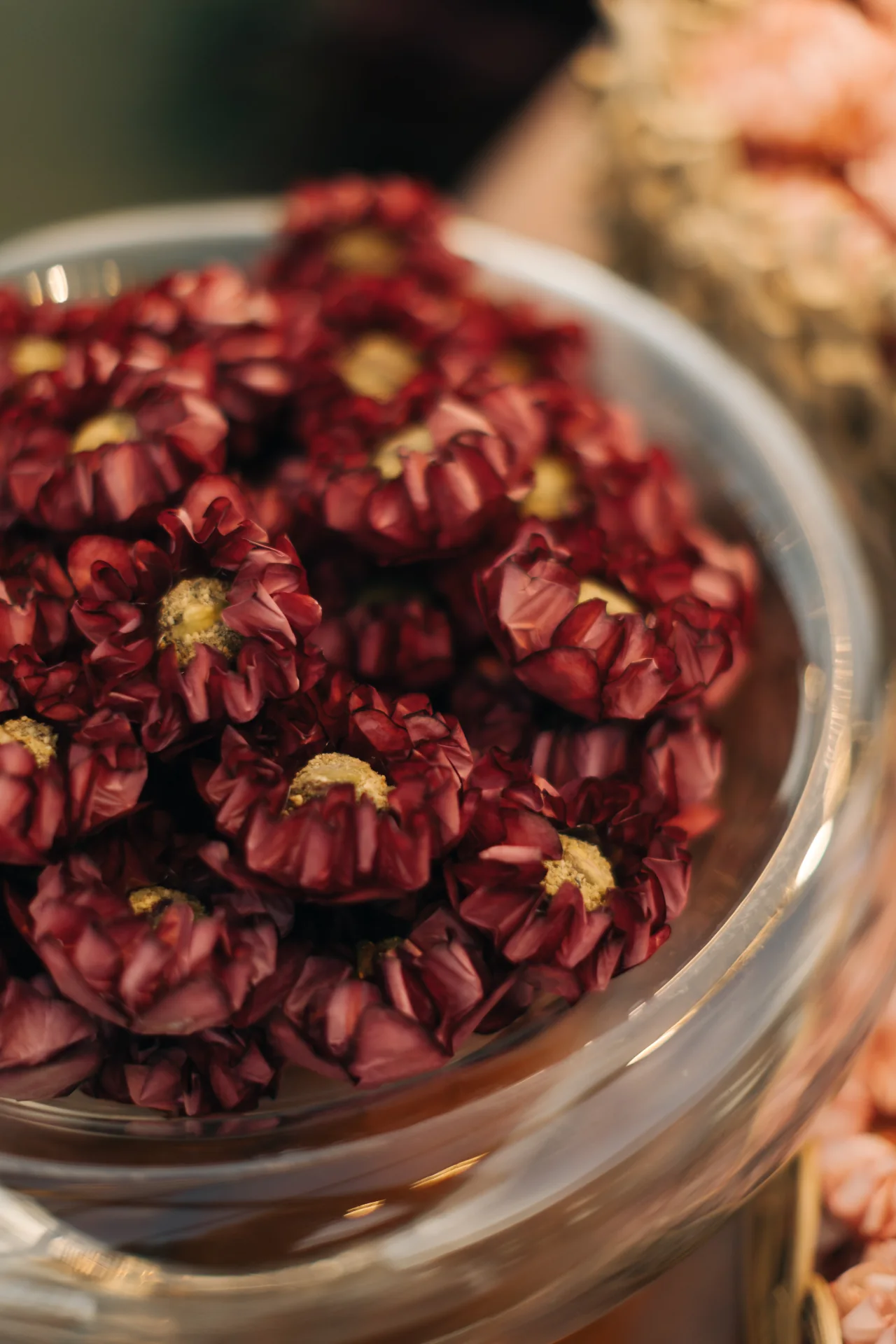 Burgundy floral bonbons in a glass bowl